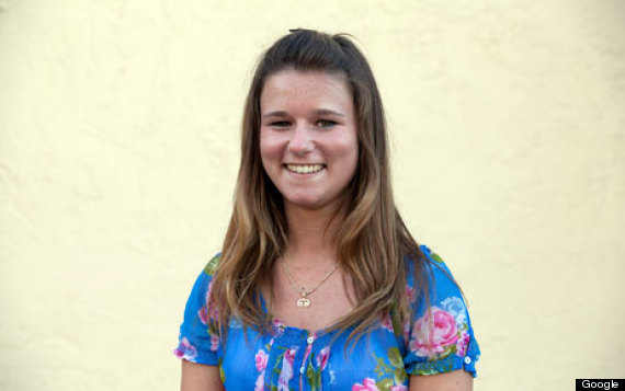 Brittany Wenger is a smiling young white girl with brown hair past her shoulders and a blue shirt with pink flowers.